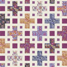 a quilt made with squares and crosses on it's sides, all in different colors