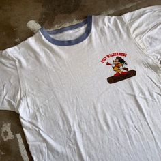 a white t - shirt with a cartoon character on it