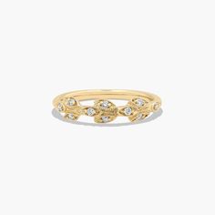 a yellow gold ring with small diamonds on the sides and a leaf design in the middle