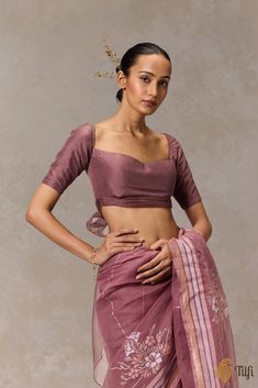 "A dainty accompaniment to any saree. Featuring a beautiful wide-neckline and a detachable pleated organza ribbon which can be tied into an exaggerated bow.\n\n\n Color - A beautiful shade of Deep Mauve\n\n Fabric - Pure Silk and Organza\nPlease allow 10-12 business days for despatch.\u00a0\n\n" Bollywood Unstitched Organza Blouse Piece, Mauve Saree Contrast Blouse, Organza Blouse Designs Latest, Sari Blouse With Bow, Pink Bollywood Blouse In Organza, Fitted Organza Bollywood Blouse, Organza Blouse Designs, Semi-stitched Purple Organza Blouse Piece, Farewell Saree