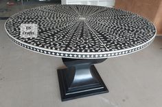 a black and white table sitting on top of a hard wood floor