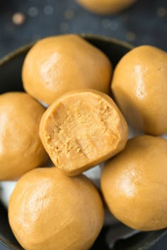 three ingredient peanut butter no bake balls in a black bowl with text overlay