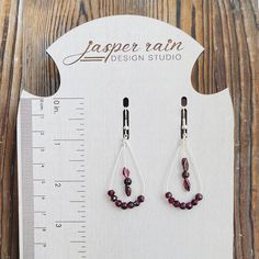 Handmade Garnet stones with stainless steel earring wires. They are 2.6 inches long. These earrings are packaged with a special card to celebrate the January birthstone Garnet and it's meaning. January CalmnessWhile the gemstone garnet can be found in a surprising amount of shades, red is the color most often associated with the January birthstone. Garnet gets its name from the Latin word "granatum," meaning "pomegranate," since its deep, glossy color resembles the fruit's seeds. According to me Garnet Drop Earrings With Ear Wire, Burgundy Teardrop Jewelry For Gifts, Handmade Burgundy Earrings For Gift, Nickel Free Garnet Earrings Gift, Nickel-free Garnet Drop Earrings, Latin Word, Earring Wires, Latin Words, Garnet Earrings