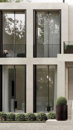 an apartment building with two balconies and windows