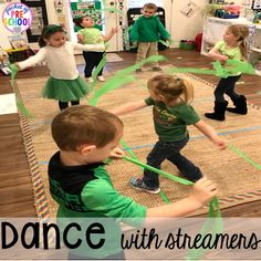 children are playing with streamers on the floor in a class at dance with streaemes