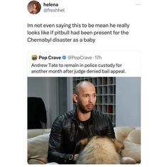 a man sitting on top of a couch next to a brown and white dog wearing a leather jacket