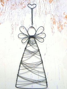 a wire christmas tree ornament with a heart on top