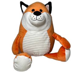 an orange and white stuffed animal sitting on top of a white surface with its paws up