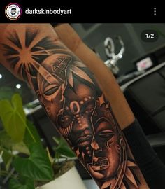 a man with a tattoo on his arm that has an image of two faces in the middle