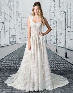 a woman in a white wedding dress standing on a brick road with her hands on her hips