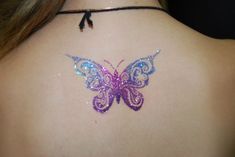 a woman with a butterfly tattoo on her back