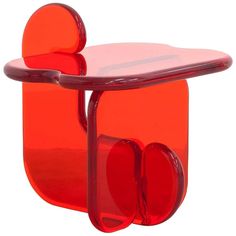 an orange glass table with two red circles on the top and one round in the middle