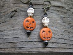 Don't you just love fall and Halloween?  These pumpkin earrings are precious for the fall and Halloween season.  The orange pumpkins have a bone howlite skull sitting on top with a daisy spacer between the skull and pumpkin.  On top of the skull is a rhinestone spacer and black bicone crystal.  A rhinestone spacer and black crystal at the bottom of the pumpkin completes the look.  The earring is approximately 2 3/8" from top of the bronze tone lever back ear wire to the bottom of the dangle.  Th Dangle Beaded Earrings For Halloween, Beaded Dangle Earrings For Halloween, Dangle Halloween Earrings, Halloween Earrings Diy, Halloween Jewelry Making Skull Beads, Handmade Skull Earrings For Halloween, Beaded Halloween, Halloween Beaded Jewelry, Sugar Skull Earrings