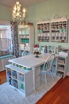 a white table and chairs in a room with lots of shelves on the wall behind it