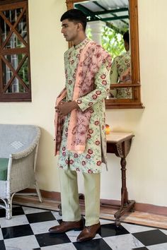 Olive green sherwani with thread, sequin, cutdana embroidery in floral pattern. Paired with trouser and peach embroidered stole. - Aza Fashions Green Cotton Sherwani With Zari Work, Anarkali Style Fitted Green Sherwani, Bollywood Style Green Sherwani With Mirror Work, Green Bollywood Sherwani With Mirror Work, Green Sherwani With Mirror Work For Eid, Pista Green Anarkali Sherwani For Eid, Fitted Green Sherwani With Dupatta, Green Sherwani With Dupatta And Straight Kurta, Green Anarkali Style Sherwani With Traditional Drape