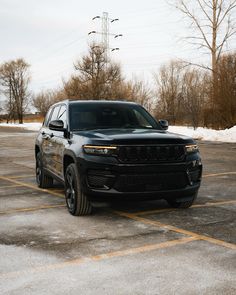 a black jeep parked in a parking lot