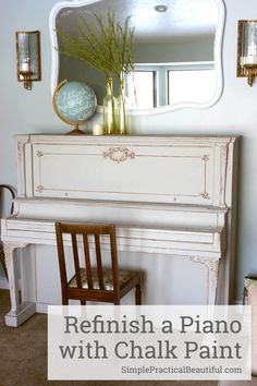 a white piano sitting in front of a mirror next to a table with a vase on it