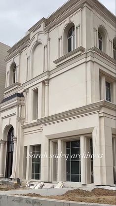 a large white building sitting on the side of a road