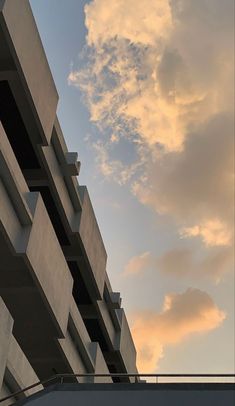 an airplane flying in the sky over a building