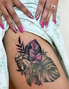 a close up of a person's stomach with tattoos on her legs and flowers