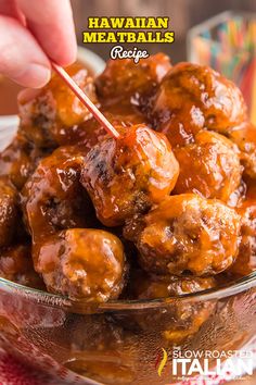 a person holding a toothpick over meatballs in a bowl with the words sweet and sour meatball recipe