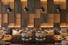 a restaurant with wooden walls and tables set up for two people to sit at the table