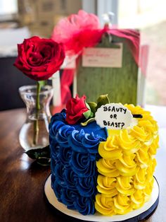 there is a cake that has been decorated with flowers on the top and below it, which says beauty or beast?