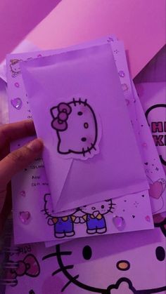 someone is holding up a hello kitty card