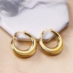 These medium-sized hoops offer a sleek and timeless design, exuding both strength and sophistication. Their waterproof feature ensures they maintain their radiance through any adventure, making them the ideal choice for modern, active lifestyles. Embrace the bold and versatile design of these earrings, which effortlessly complement both casual and formal looks, adding a touch of enduring luxury to your everyday style.Diameter: 4cmStainless Steel;18K Gold Plated;Nickel-free, Hypoallergenic & Wate Round Earrings Circles Gold, Thick Hoop Earrings, Chunky Hoop Earrings, Metal Fashion, Waterproof Jewelry, Trendy Earrings, Girls Earrings, Circle Earrings, Trendy Jewelry