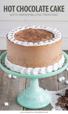 a chocolate cake with marshmallows is on a green plate next to a piece of cake