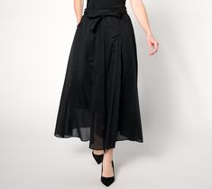 Sashay through the streets knowing all eyes will be on you in this feminine, flowy midi skirt. The chic bottom ties at the waist, accentuating your curves and creating a flattering silhouette. From BEAUTIFUL by Lawrence Zarian. Summer Belted Long Skirt, Chic Flowy Gathered Skirt Bottoms, Chic Flowy Gathered Skirt, Chic Flowy Flared Skirt Bottoms, Elegant Spring Bottoms With Tie Waist, Relaxed Midi Wrap Skirt With Tie Waist, Asymmetrical Tie Waist Relaxed Skirt, Spring Asymmetrical Wrap Skirt With Tie Waist, Asymmetrical Wrap Skirt With Tie Waist For Spring