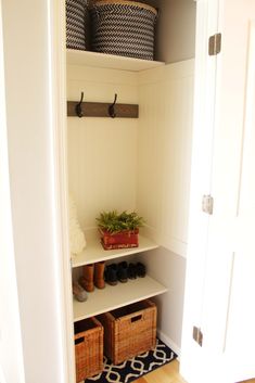 a white closet with baskets and shoes on the shelves next to it is shown in this image