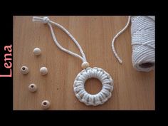 the yarn is being used to make an ornament with beads and cottons