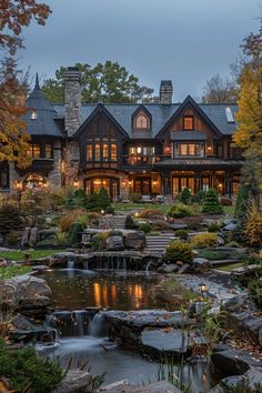 a large house with a waterfall in front of it