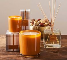 an orange candle sitting on top of a wooden table