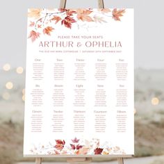 a wedding seating chart with fall leaves on it