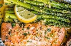 salmon and asparagus wrapped in foil with lemon wedges