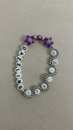 a beaded bracelet with the word awesome written on it and purple beads in the middle