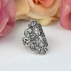 "Elevate your style with our stunning Sterling Silver Filigree Art Lace Embroidery Long Statement Ring. This intricate and elegant ring features delicate filigree work in a beautiful lace-like pattern, making it a perfect addition to any outfit. Made from high-quality sterling silver, this ring is both durable and stylish. Its long and bold design adds a touch of glamour to any occasion, making it perfect for both formal and casual wear. Shop now and make a statement with our Sterling Silver Filigree Art Lace Embroidery Long Statement Ring! Ring Length: 1.15\" and Width: 0.60\"  This metal embroidery filigree ring is oxidized and highly polished.  Comes with a velvet pouch, silver polish cloth and a luxurious gift box. Filigree is made of delicate metal strands that have been skillfully fa Ornate Oxidized Filigree Ring For Anniversary, Elegant Oxidized Filigree Ring For Anniversary, Traditional Filigree Ring For Anniversary, Elegant Silver Filigree Flower Ring, Ornate Sterling Silver Filigree Ring, Silver Filigree Flower Ring Gift, Silver Filigree Flower Ring As Gift, Silver Filigree Open Ring, Silver Filigree Flower Ring For Anniversary