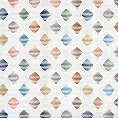 a white background with multicolored squares and dots in different colors on the fabric