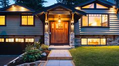 a house with lights on in the front yard