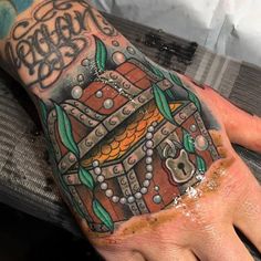 a person's hand with a tattoo on it