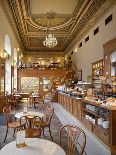 the inside of a restaurant with many tables and chairs