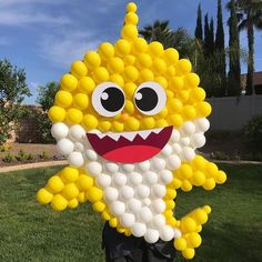 a large balloon in the shape of a cartoon character with big eyes and yellow teeth