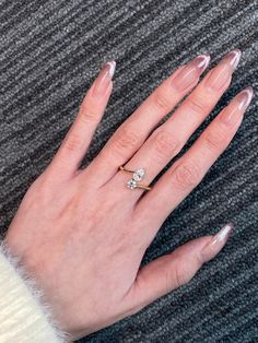 a woman's hand with clear manies and a diamond ring on it,