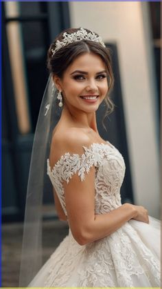 a woman in a wedding dress is smiling for the camera with her veil over her head