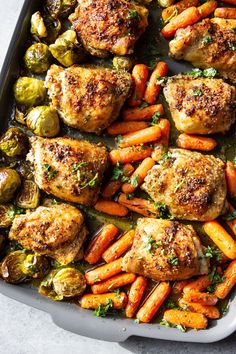 chicken thighs, carrots and brussel sprouts in a baking dish