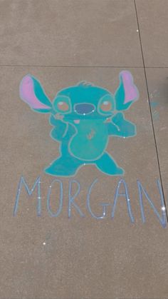 the sidewalk has been drawn with chalk and is decorated with an image of a cartoon character