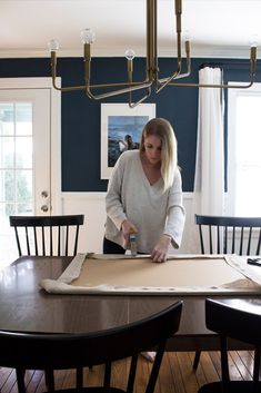 a woman is making something on top of a table