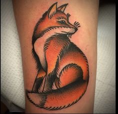 an orange and black fox tattoo on the leg, with its tail curled up to it's chest